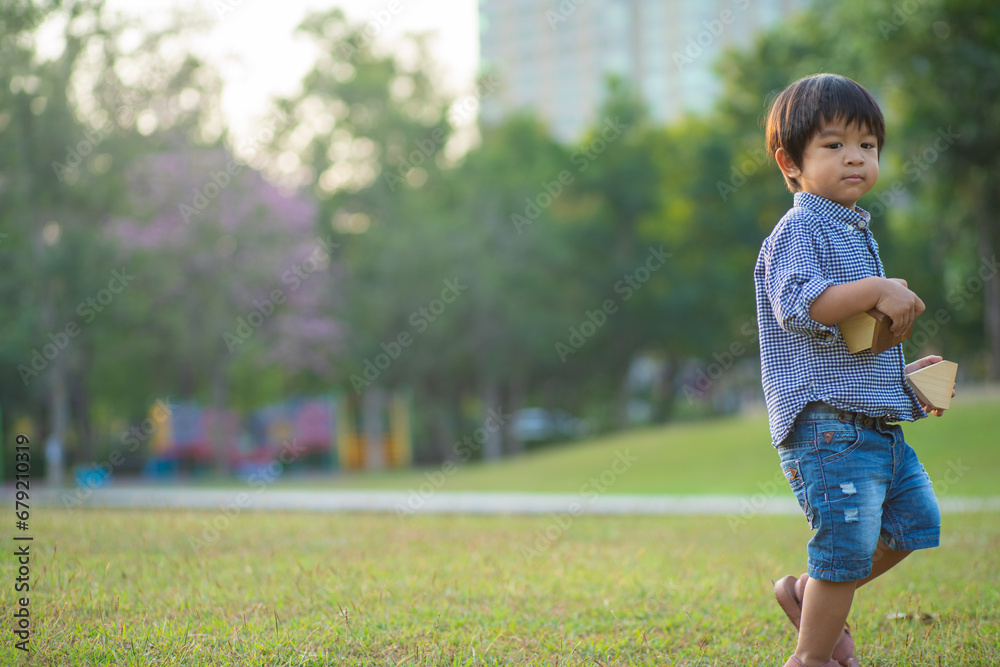 Asian preschool boy enjoying outdoor recreation city park sunset light Asian preschool boy enjoying outdoor recreation city park sunset light
