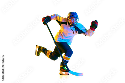 Champion. Young girl, hockey player in motion, wearing uniform, playing with stick against white background in neon light. Concept of professional sport, competition, game, action, hobby