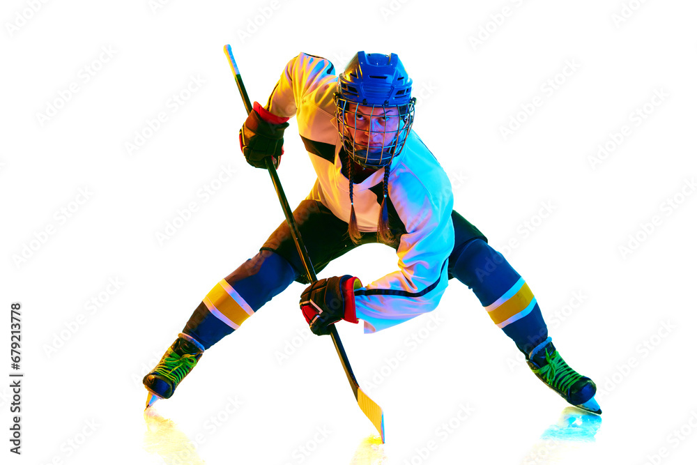 Goalkeeper. Concentrated young girl, hockey payer ion motion, standing with stick during game against white background in neon light. Concept of professional sport, competition, game, action, hobby Goalkeeper. Concentrated young girl, hockey payer ion motion, standing with stick during game against white background in neon light. Concept of professional sport, competition, game, action, hobby