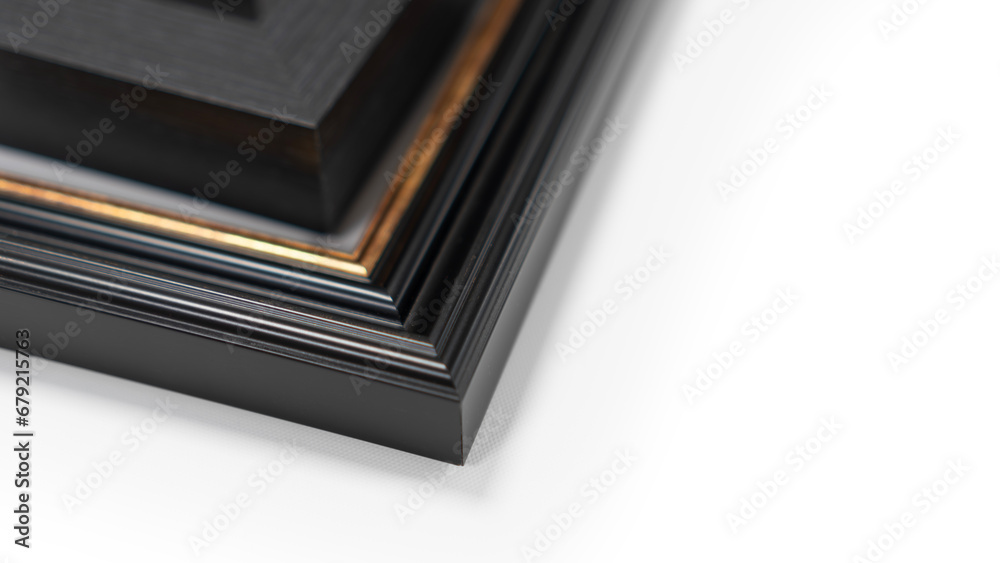 A pile of empty picture frames and mouldings on a clean white background A pile of empty picture frames and mouldings on a clean white background