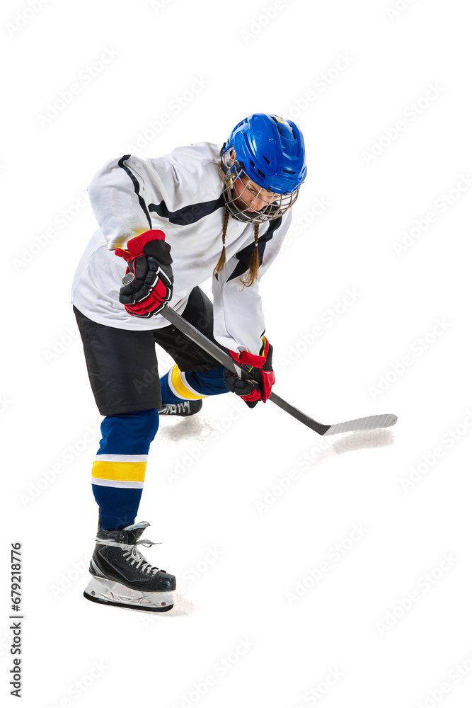 Obraz premium Young girl, hockey playing in helmet, uniform, with stick training, playing isolated over white background. Concept of professional sport, competition, game, action, hobby, achievements