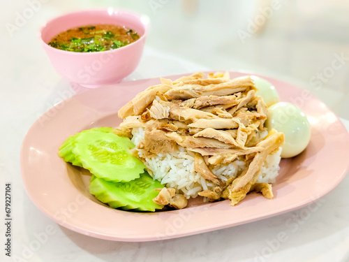 Steamed rice topped with chicken on the dish. Thai delicious food.