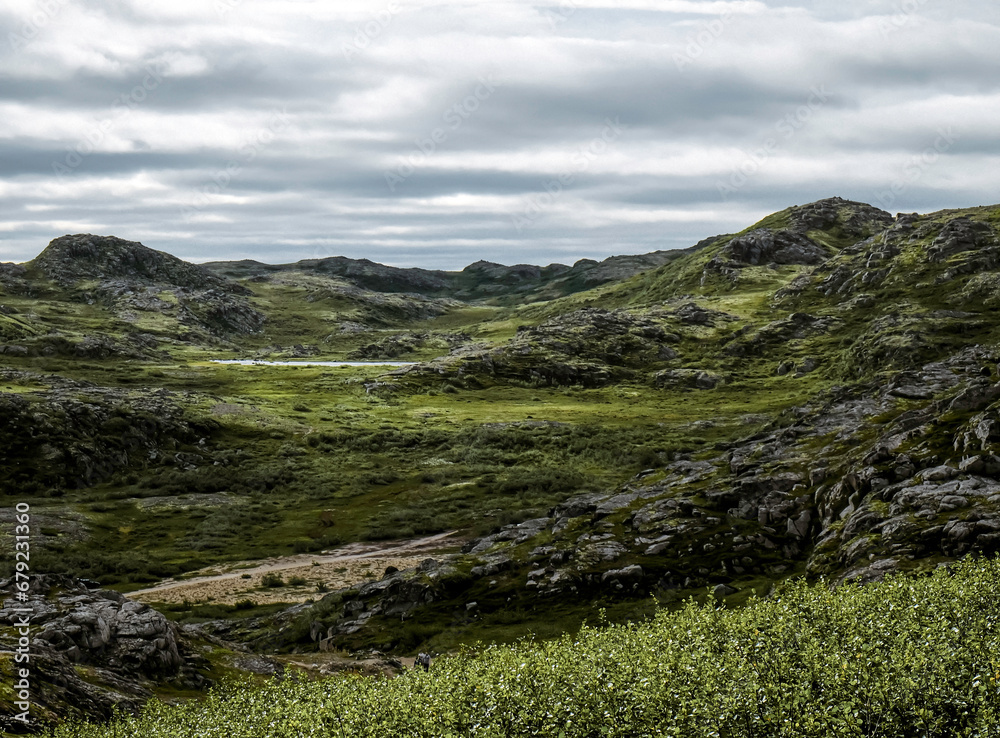 Landscape of green polar rocky tundra. Northern nature of Teriberka