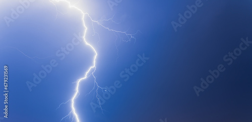 Lightning from the black and blue sky. Storm clouds.