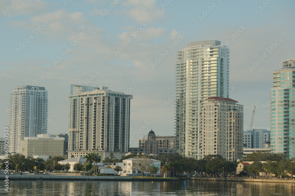 Cityscape of water with tall buildings on a sunny day with boats in the foreground. With a blue sky on a sunny day at the Vinoy  Basin waterfront in St. Petersburg, Florida.
