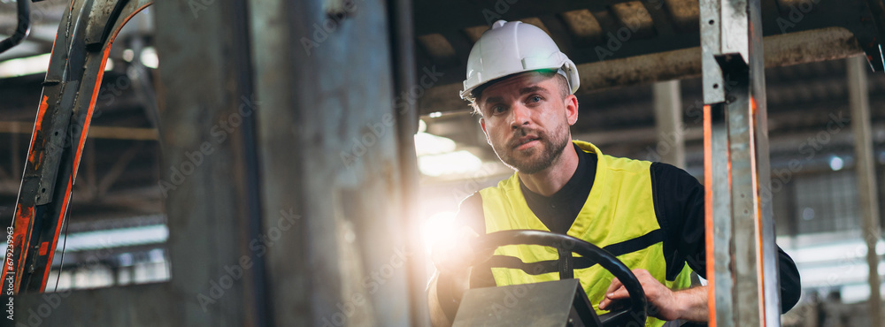 Industrious Engineer Operating Forklift in Warehouse. Efficient Forklift Driving in Factory. Engineer is working and maintaining in the factory. Industrious Engineer Operating Forklift in Warehouse. Efficient Forklift Driving in Factory. Engineer is working and maintaining in the factory.