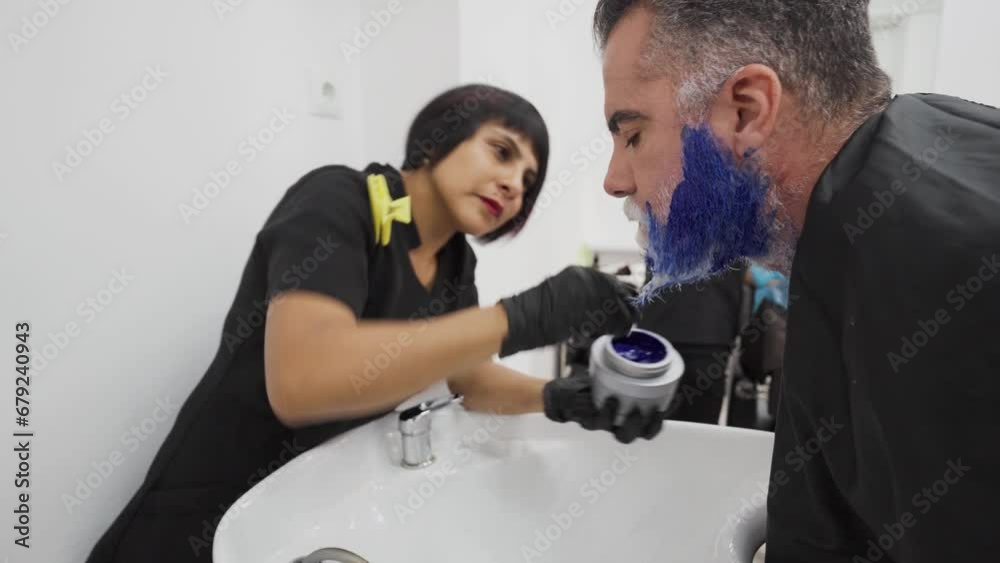 Stylist applying anti-yellow shampoo to client beard during dyeing process.MOV Stylist applying anti-yellow shampoo to client beard during dyeing process.MOV