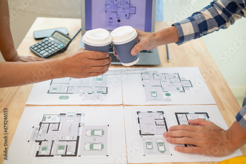 Teams engineers, architects and real estate investors churned over cup of hot coffee to congratulate them their successful project design within budget. Hot coffee clash concept to celebrate in office