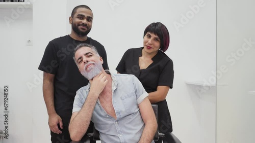 African customer posing and interacting with hairdressers after beard dyeing.MOV photo