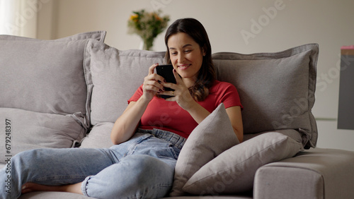 Woman using smartphone. Happy caucasian female enjoy online chat, internet purchase, browse web, download new cool freeware application. 