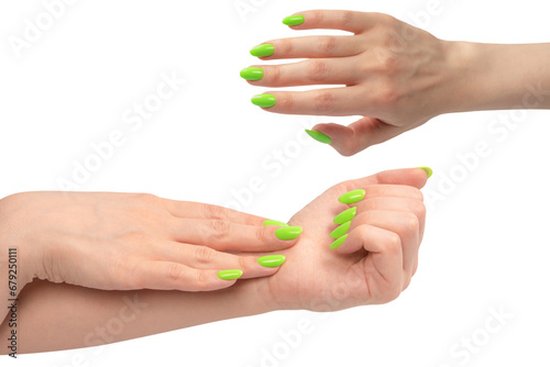 Hand of a woman with green naols hold some tiny or thin object.