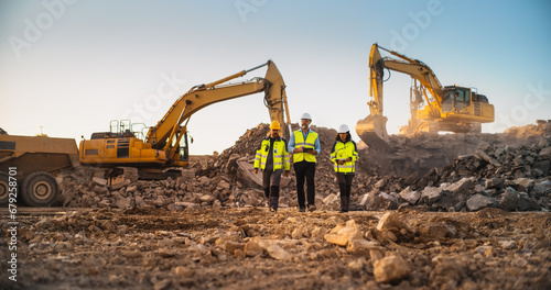 Construction Site With Excavators on Sunny Day: Diverse Team Of Male And Female Specialists Walking And Discussing Real Estate Project. Civil Engineer, Architect, Urban Planner Talking, Using Tablet.