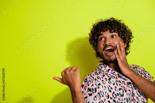 Photo portrait of attractive young male point empty space shocked wear trendy leopard print clothes isolated on yellow color background