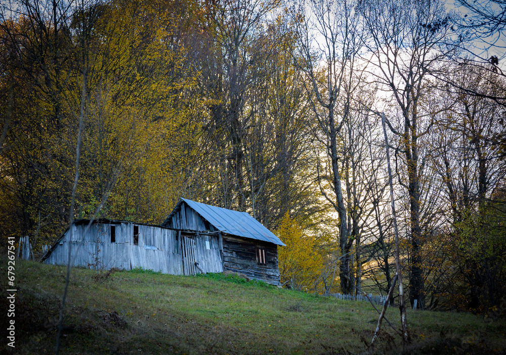 Abandoned wooden house. The little wooden house on the hill, autumn.
