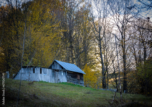 Abandoned wooden house. The little wooden house on the hill, autumn.