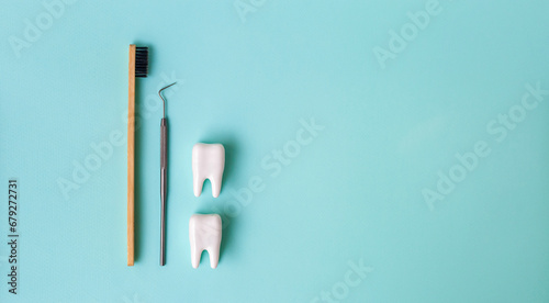Dental model and dental equipment on blue background, concept image of dental background. Dental probe. Toothbrush. Banner. Dental health concept. Oral health examination and dental examination.