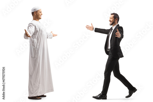 Businessman meeting a muslim friend in ethnic clothes