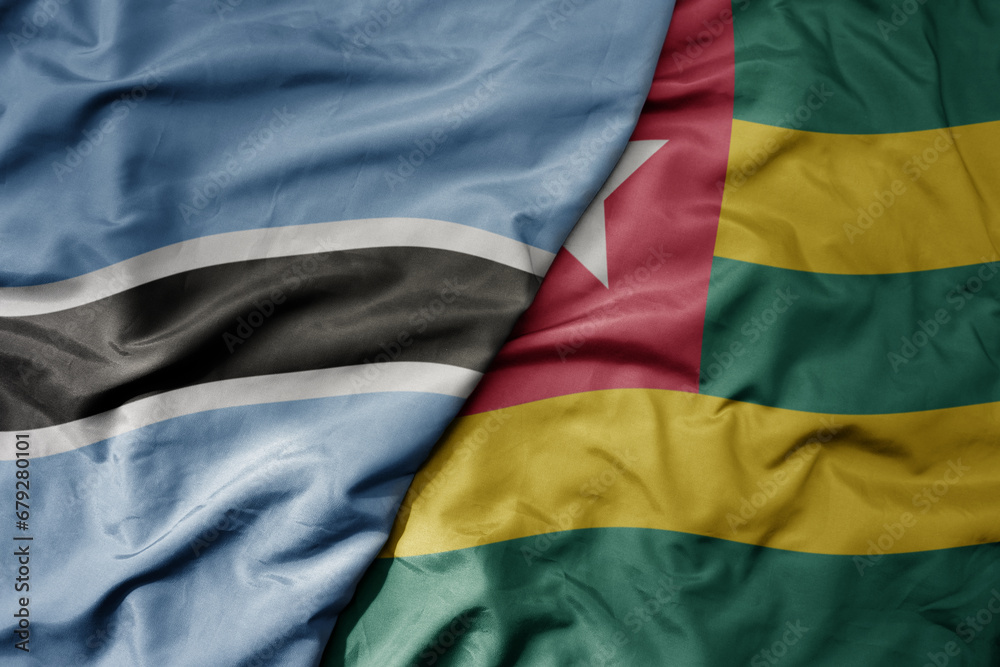 Obraz premium big waving national colorful flag of botswana and national flag of togo .