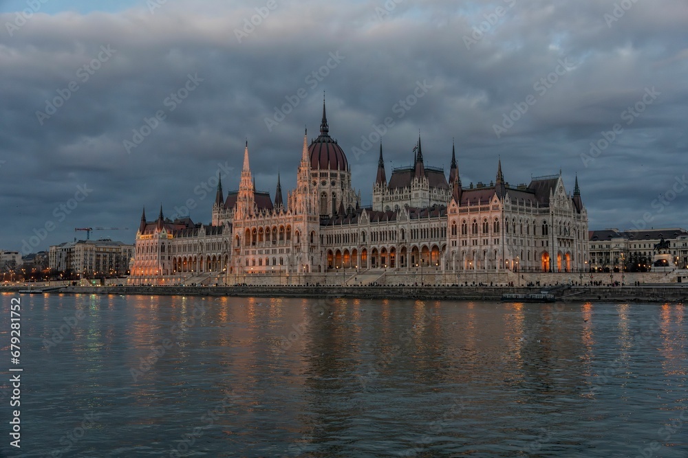 Majestic Hungarian Parliament building stands against a stunning backdrop of dark clouds