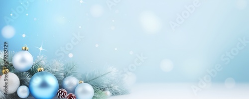 Christmas tree branch decorated with New Year's toys light blue background, banner 
