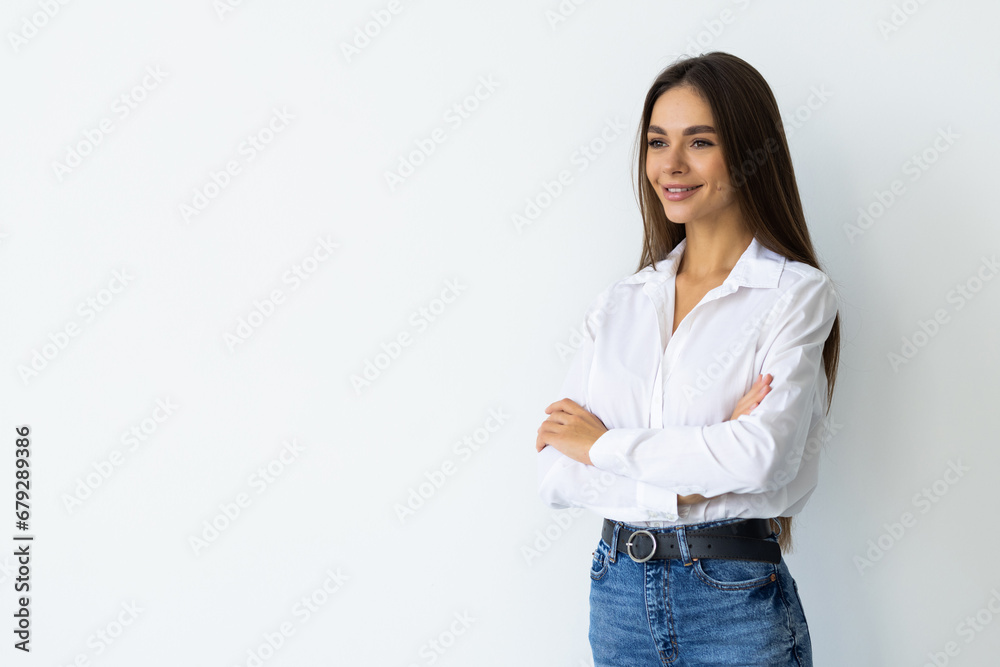 Portrait of a happy woman standing with arms folded on a white background Portrait of a happy woman standing with arms folded on a white background