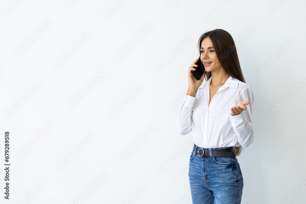 Portrait of a smiling woman talking on mobile phone isolated over white background Portrait of a smiling woman talking on mobile phone isolated over white background