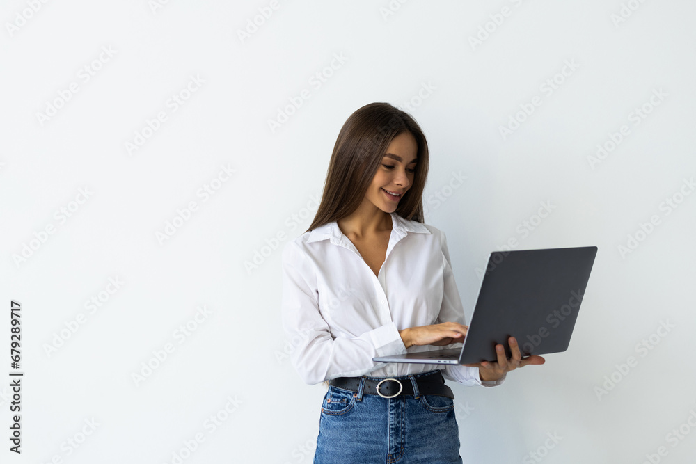 Portrait of a happy woman working on laptop isolated over white background Portrait of a happy woman working on laptop isolated over white background