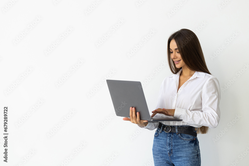 Portrait of young woman in casual outfit with laptop isolated on white background Portrait of young woman in casual outfit with laptop isolated on white background