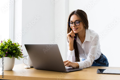 Cheerful and successful woman programmer at work inside modern office  tech support worker with laptop t