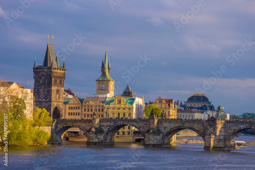 Charles Bridge (Karluv Most) on Vltava river and Old Town Bridge Tower, famous tourist destination in Prague, Czech Republic (Czechia), at sunset