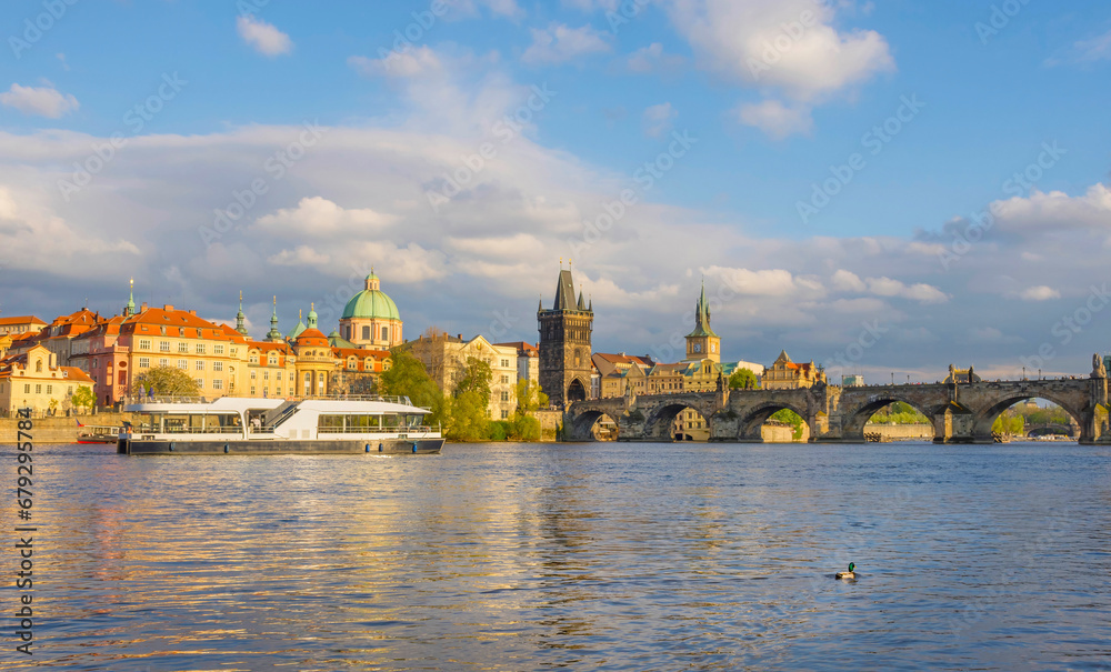 Charles Bridge (Karluv Most) on Vltava river and Old Town Bridge Tower, famous tourist destination in Prague, Czech Republic (Czechia), at sunset