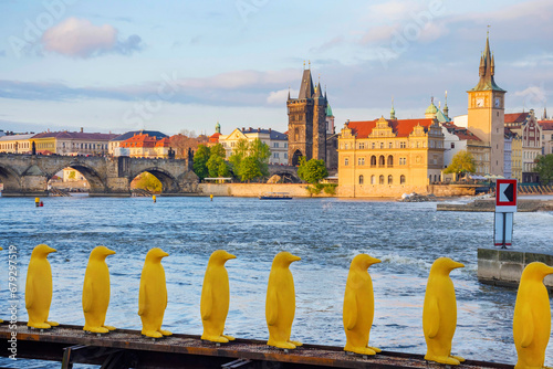 Obraz na płótnie Museum Kampa's Yellow Pinguins, modern art in Prague, Czech Republic and view of old town with Charles Bridge on Vltava river in the background, at sunset w salonie