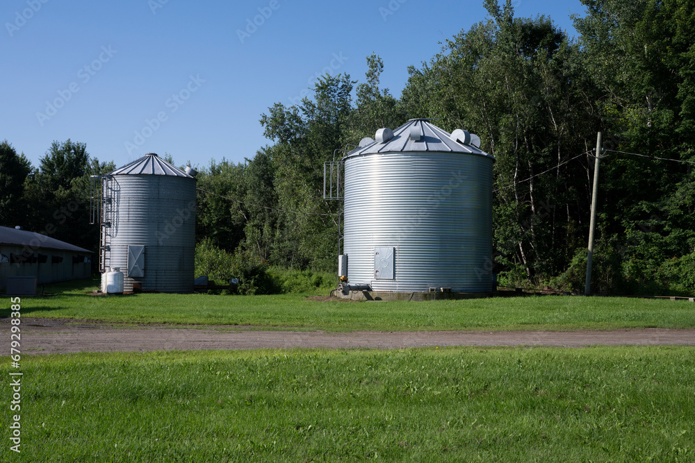 Two steel silos for grain on a farm Two steel silos for grain on a farm