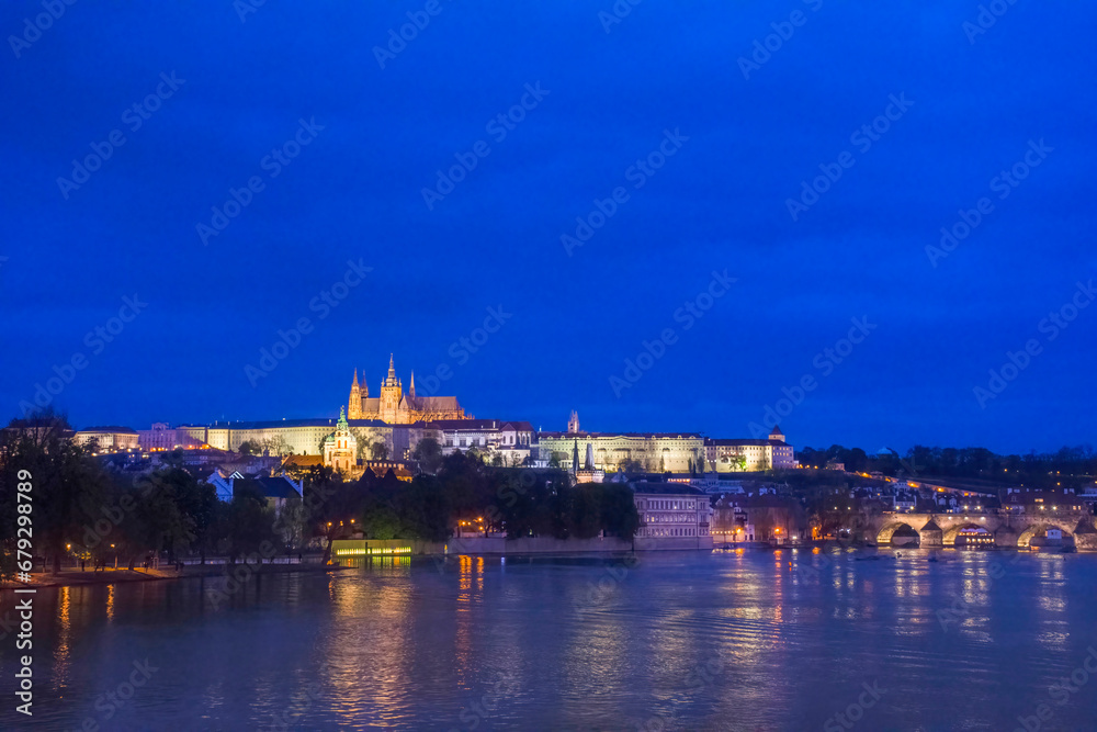 Vltava river with famous Hradcany castle and St. Vitus Cathedral in Prague, Czech Republic, by night