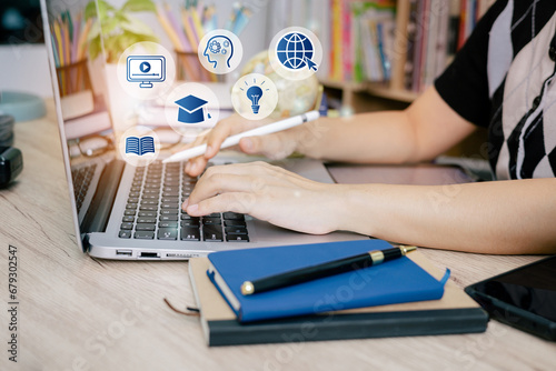A young student engaged in e-learning using a laptop, accompanied by virtual education icons