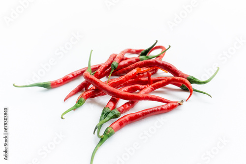Indonesian best quality red hot chilies. A bunch of fresh curly red chilies isolated on white background. In Indonesia, it is commonly called Cabai Merah Keriting. photo