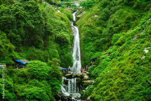 Majestic landscape of Bhagsu Nag waterfall and green forest around at Mcleodganj, Himachal Pradesh, India. photo