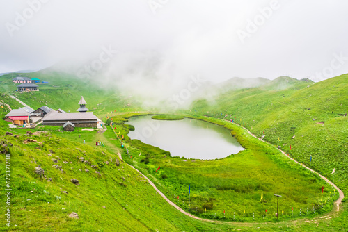 View at Prashar Lake located at a height of 2730 m above sea level with a three storied pagoda-like temple of sage Prashar near Mandi, Himachal Pradesh, India. The lake has a floating island in it.