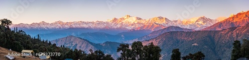 Panoramic view during sunset over snow cladded gangotri group mountain peaks falls in Greater Himalayas mountain range from Chopta, Uttarakhand, India. photo