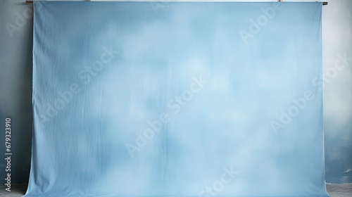 Painted canvas or muslin fabric cloth studio backdrop or background, suitable for use with portraits, products and concepts. Light blue painted design. photo