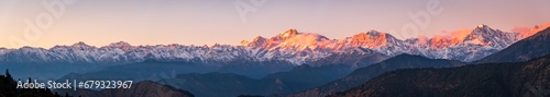 Panoramic view during sunset over snow cladded gangotri group mountain peaks falls in Greater Himalayas mountain range from Chopta, Uttarakhand, India. photo