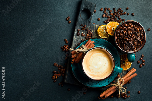 A cup of cappuccino and coffee beans. Top view, on a black background, free copy space. Robusta or Arabica. © Yaruniv-Studio