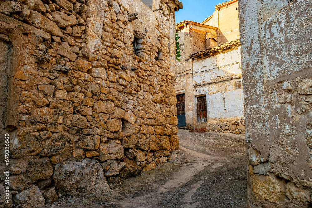 View of a typical street of a village in Rincón de Ademuz called Casas Altas in Spain. Vernacular architecture