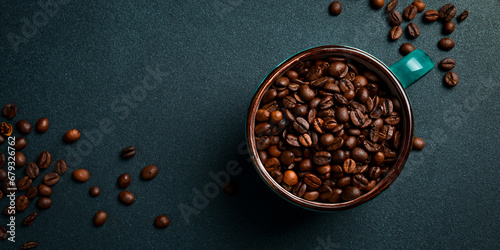 A cup with roasted robusta or arabica coffee beans. Top view On a dark background.