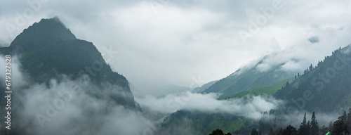 Serene Landscape cloud shrouded mountains of Pir panjal range near Atal Tunnel in Manali of Himachal Pradesh, India. photo