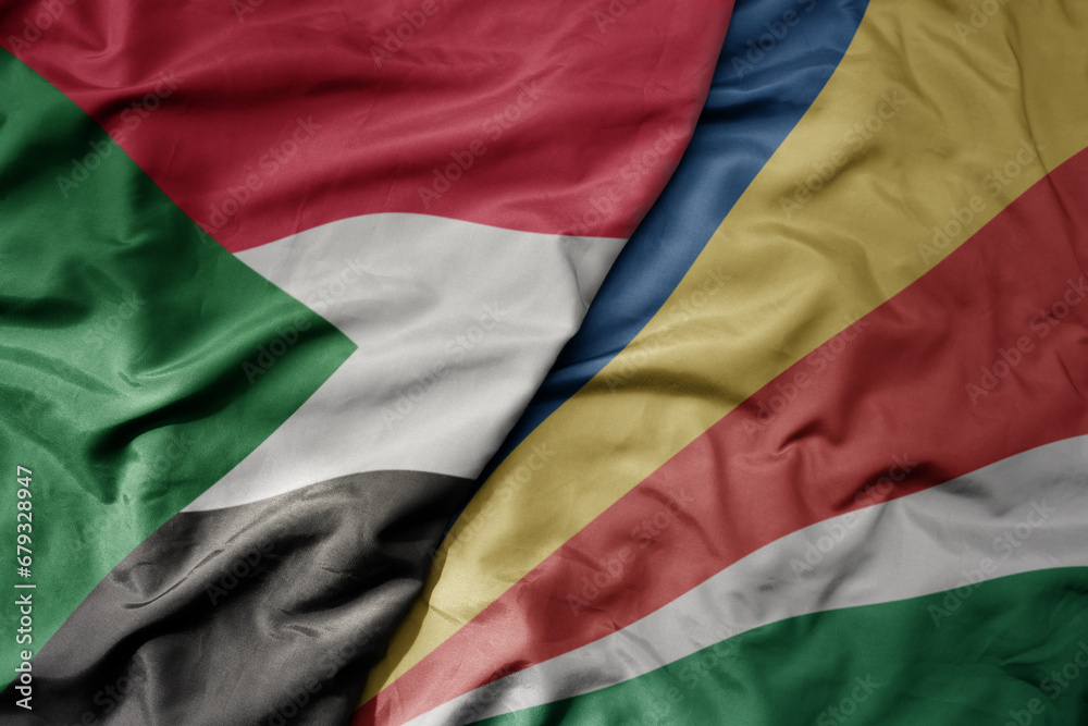 Obraz premium big waving national colorful flag of sudan and national flag of seychelles .
