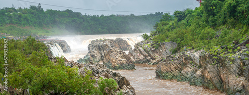 Dhuandhar waterfall on Narmada river has been named so because of the smoky appearance of the water falling off the cliff with utmost force at Jabalpur, Madhya Pradesh, India. photo