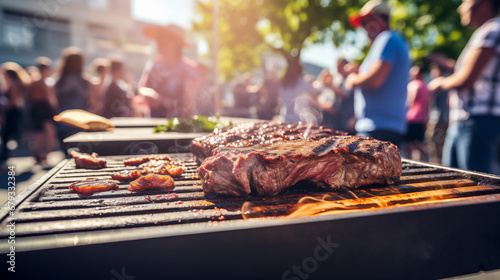 A large steak is cooking on a grill photo