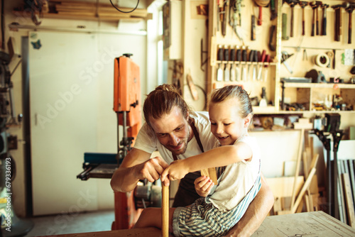 Father and Daughter Enjoying Craft Time in a Woodworking Workshop