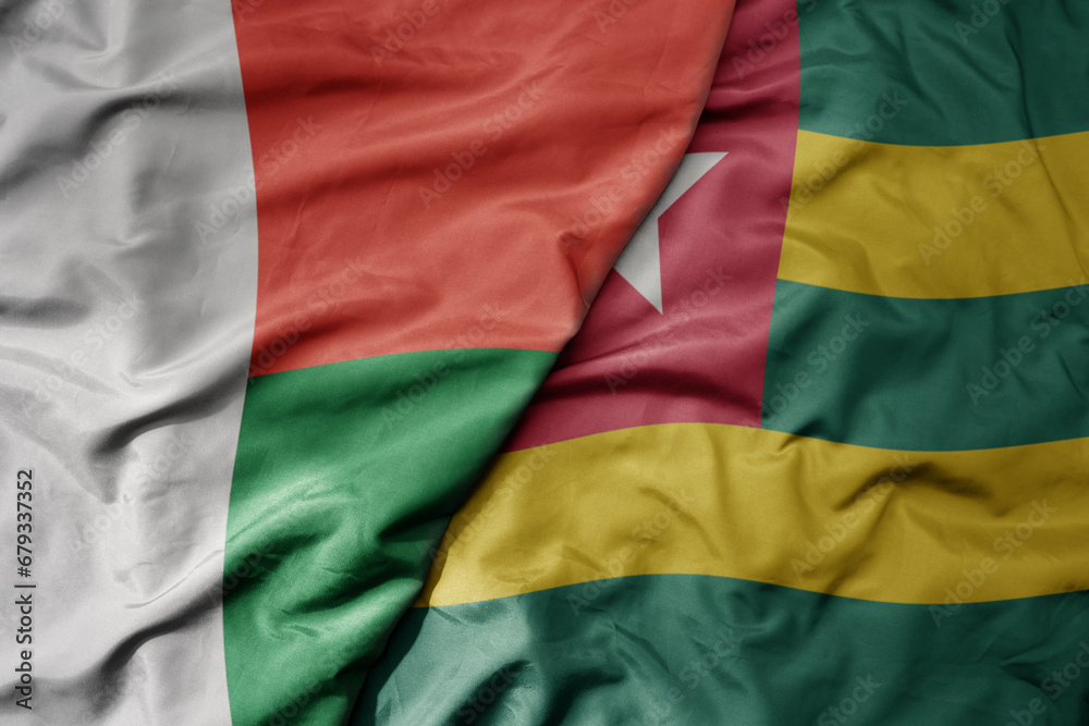 Obraz premium big waving national colorful flag of madagascar and national flag of togo .